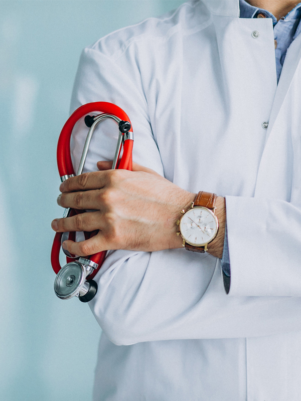 Young handsome physician in a medical robe with stethoscope